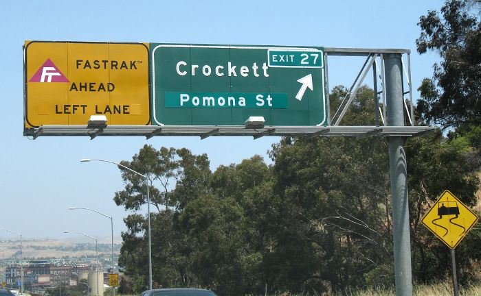 Retrofitted exit number along with Fastrak lane-warning sign on Interstate 80 eastbound in Crockett