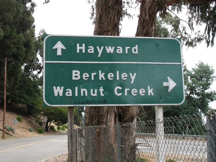 Button reflectors on destination sign at California 13 in Oakland 