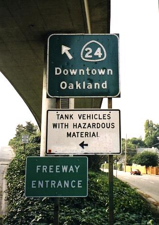 California 24 entrance sign w/ hazardous materials warning