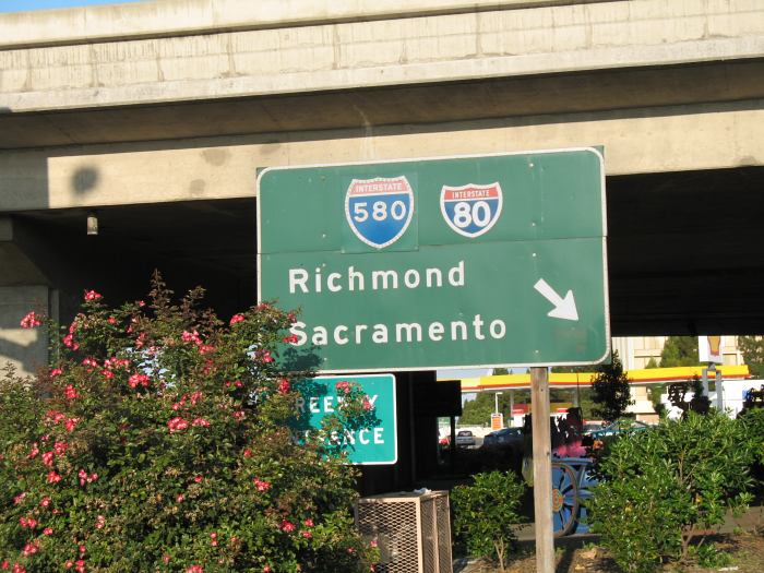 Freeway entrance on Powell Street in Emeryville, California (big green sign)