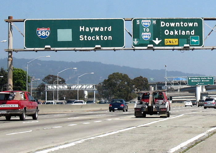 Leftover letters on patched-up sign for Interstate 980 in Oakland