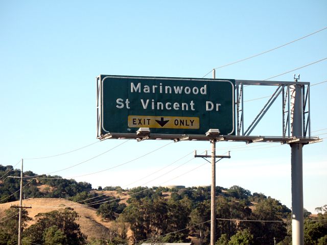 Button reflectors show up in relief on this exit sign on US 101 in Marinwood, California