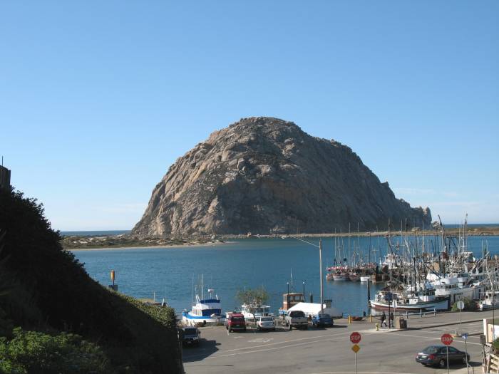 Morro Rock overlooking boats in the Morro Bay harbor, California