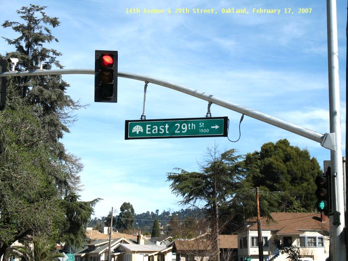 Clearview font on Oakland city street sign on signal mast at 14th Avenue