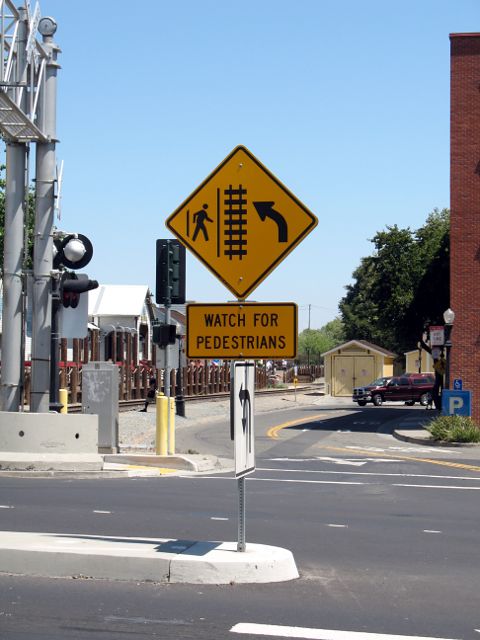 Complex pedestrian warning sign on Capitol Mall in Sacramento, California