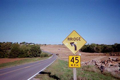 In opposite direction, curve sign for the same bridge on US 59