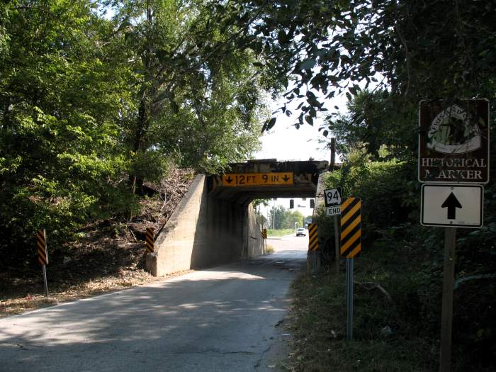 Railroad overpass provides a narrow passageway to US 67 from Missouri 94