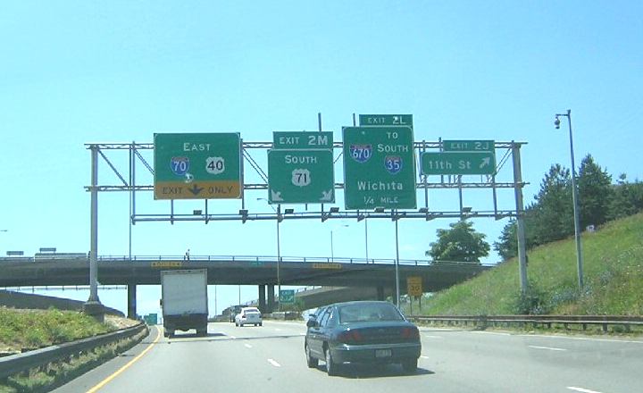 Advance signs for exits on the downtown freeway loop in Kansas City, Mo.