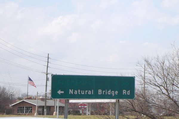 Fading remnant of direction to St. Charles, Mo. on destination sign in St. Louis County