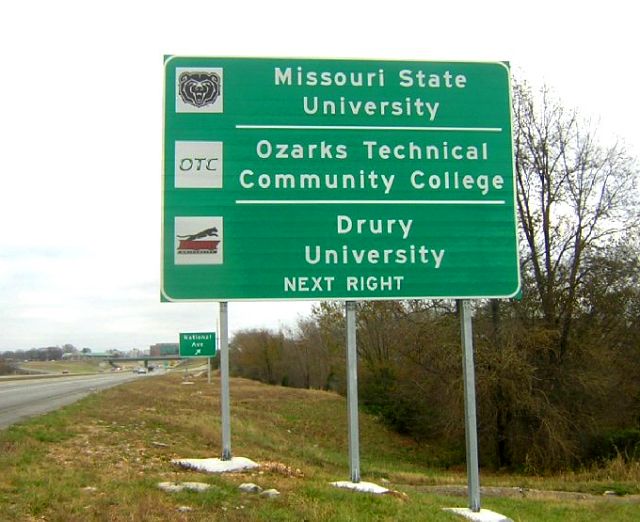 Signs for colleges at National Avenue in Springfield, Mo.