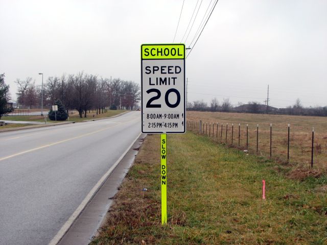 Slow-down message on school-zone sign post in Nixa, Mo.