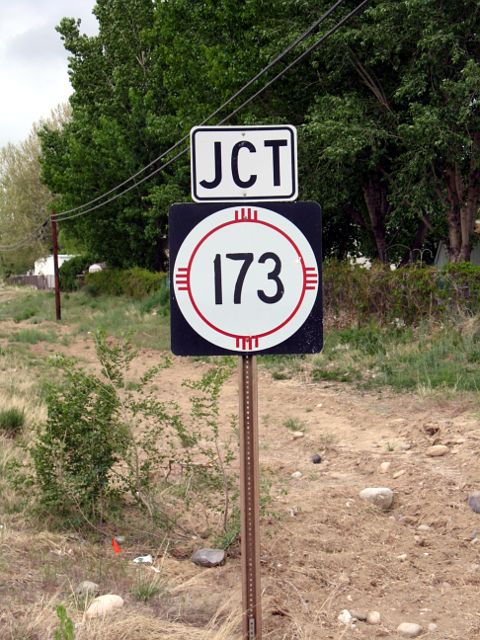 Slightly worn marker for NM 173 on US 550 in Aztec