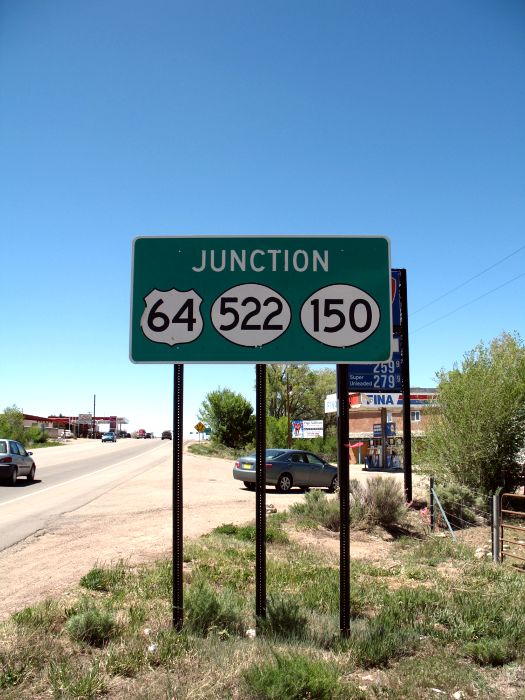 Single-panel junction sign on westbound US 64 north of Taos, New Mexico