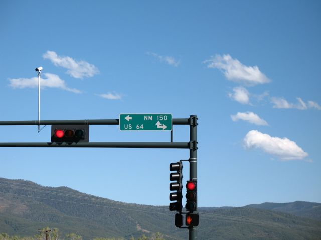 Directions for US 64 and NM 150 on signal mast arm