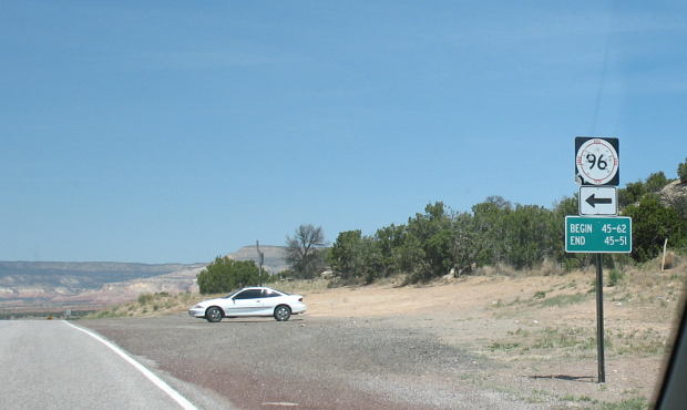 Shot-up NM 96 marker on US 84 in Rio Arriba County