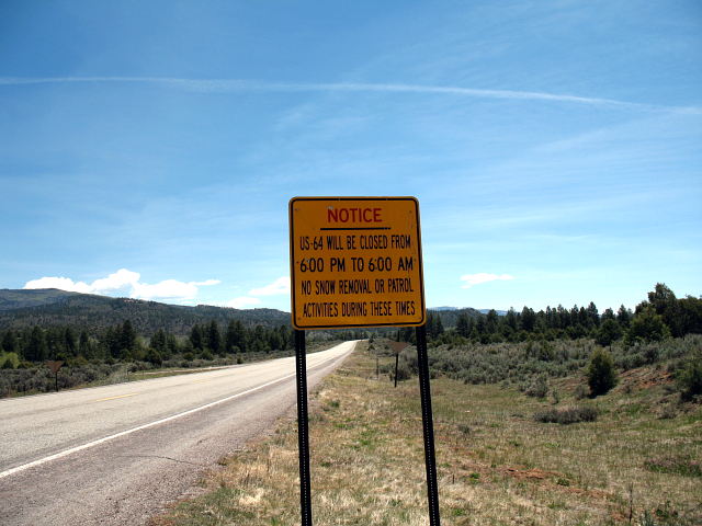 Typical New Mexico-style 'notice' sign on US 64 eastbound in Tierra Amarilla