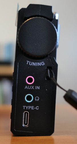 The right side of the Lijiani RD239 radio/media player-recorder, showing a large knurled tuning knob, an input jack for recording, an output jack for listening with headphones, and a USB-C port for charging and computer connection
