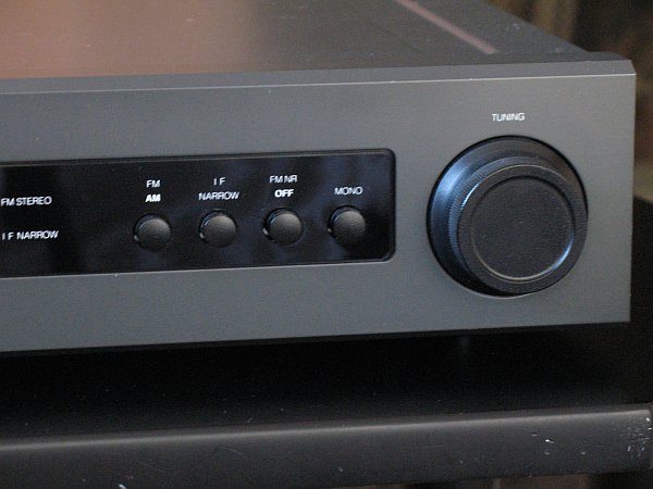 Right side of the front panel of the NAD 4300 AM/FM tuner, showing controls for band selection (AM or FM), bandwidth selection (push in for narrow), noise reduction (push in to turn off), and stereo or mono (push in for mono). The tuning knob is also shown.