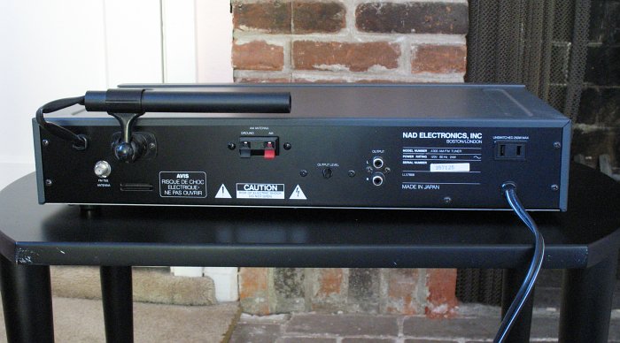 Rear panel of the NAD 4300 AM/FM tuner, showing output jacks, an AM antenna, AM and FM antenna connectors, a power outlet, and text with the model numer and that it was made in Japan.