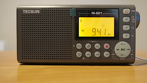 Tecsun M-601, showing the 'heart' symbol used to indicate a favorite station stored outside the usual bank of memory positions