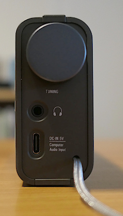 Right side of the Tecsun M-601, showing its ports and a tuning/volume knob