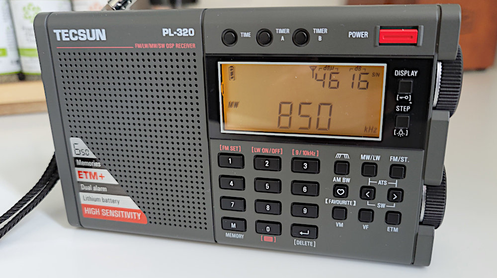 Tecsun PL-320 AM/FM/SW radio tuned to KOA(AM) Denver