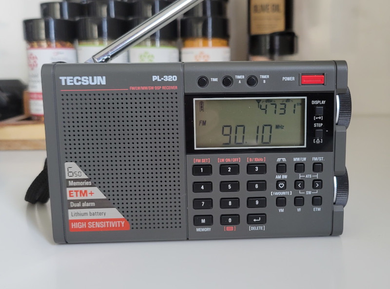 Tecsun PL-320 AM/FM/SW radio tuned to KCFR(FM) Denver