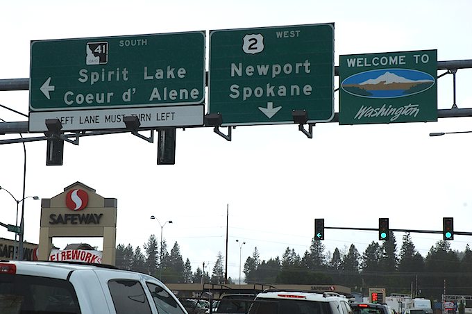 Close-up view of the overhead signs at the Washington-Idaho border on US 2