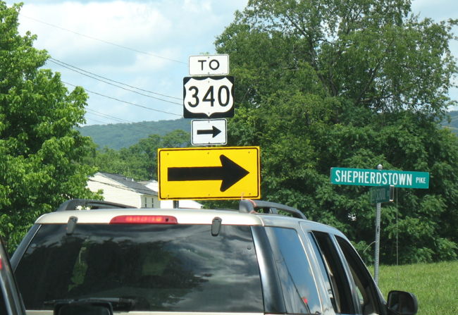 Normal turn around and large yellow warning arrow for US 340 on West Virginia 230